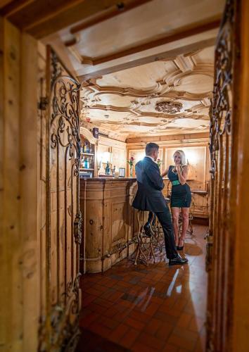 a man and a woman standing in a kitchen at Hotel Restaurant Häupl in Seewalchen