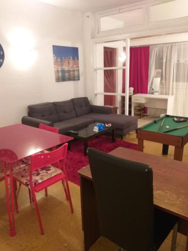 a living room with a couch and a pool table at Appartement Agdal / nuitée in Rabat