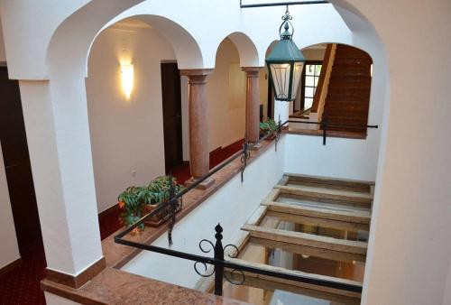 a view of a hallway with stairs and a light at Hotel Restaurant Häupl in Seewalchen