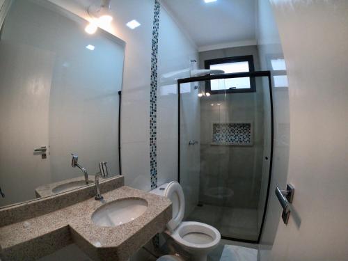 a bathroom with a sink and a toilet and a shower at Hotel Tertulio's in Rio Claro