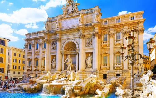 a building with a fountain in front of a building at Hotel Homs in Rome