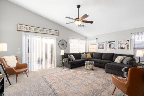 a living room with a couch and a ceiling fan at Maricopa Home Less Than 1 Mile to The Duke Golf Course! in Maricopa