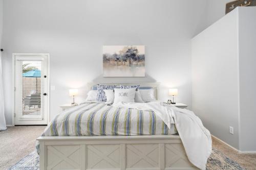 a white bedroom with a bed and two lamps at Maricopa Home Less Than 1 Mile to The Duke Golf Course! in Maricopa
