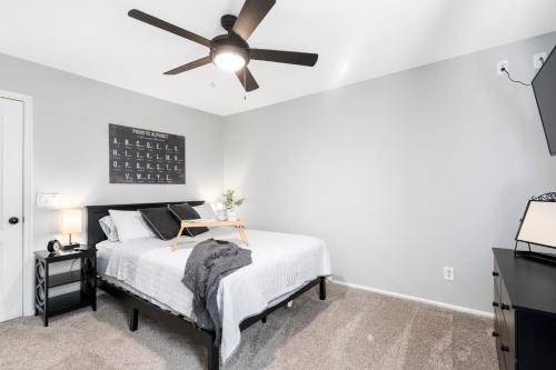a bedroom with a bed with a ceiling fan at Maricopa Home Less Than 1 Mile to The Duke Golf Course! in Maricopa