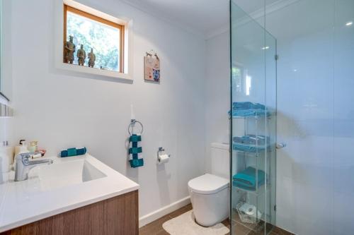 a bathroom with a sink and a glass shower at The Sanctuary Studio in Rye