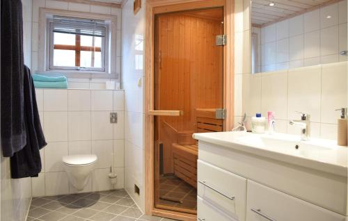 a bathroom with a toilet and a sink at Nice Home In Norheimsund With Sauna, 5 Bedrooms And Wifi in Norheimsund
