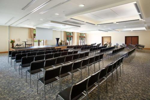 a room with rows of chairs in a room with a stage at Radisson Blu Hotel Paris, Marne-la-Vallée in Magny-le-Hongre