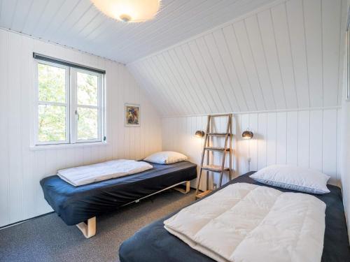 a bedroom with two beds and a ladder in it at Holiday home Nørre Nebel XLIX in Nørre Nebel