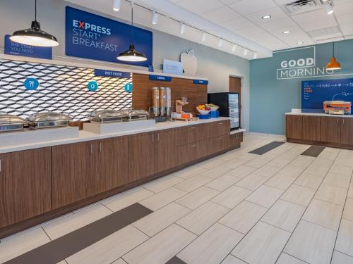 a fast food restaurant lobby with a good morning sign at Holiday Inn Express & Suites - Ruskin by IHG in Ruskin