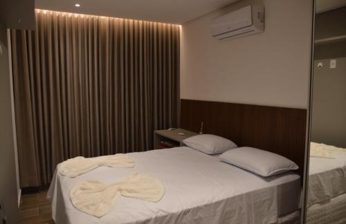 a hotel room with a bed with towels on it at Pousada Flor de Alter in Alter do Chao