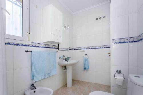 a white bathroom with a sink and a toilet at CH Aracena La Marquesa Golf (Ciudad Quesada) in Ciudad Quesada