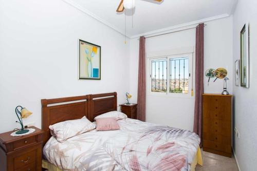 a bedroom with a bed and a window at CH Aracena La Marquesa Golf (Ciudad Quesada) in Ciudad Quesada