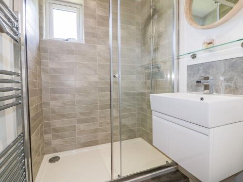 a bathroom with a shower and a sink at 24 Meadow Retreat in Liskeard