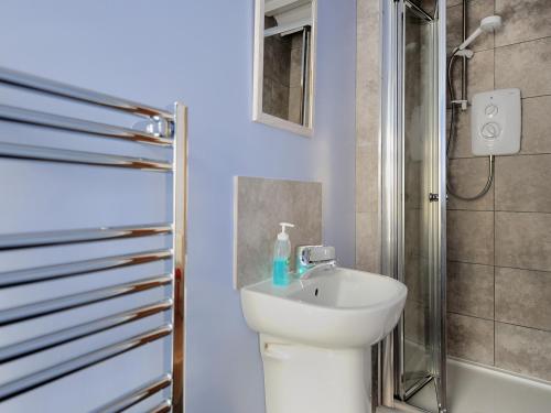 a bathroom with a sink and a shower at 3 Cobb View in Lyme Regis