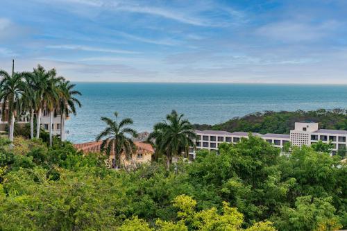 a view of the ocean and buildings and trees at 1053 - Villa Anka in Tangolunda