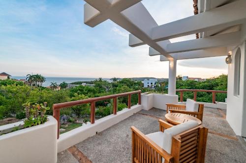 a balcony with chairs and a view of the ocean at 1053 - Villa Anka in Tangolunda