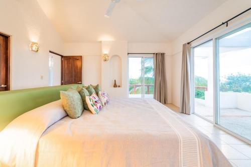 a large bedroom with a large bed with pillows at 1053 - Villa Anka in Tangolunda