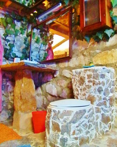 a painting of a stone wall with a toilet at Sidarta, Casa Grande - Bella Casita, Casa Pequeña in Chocontá