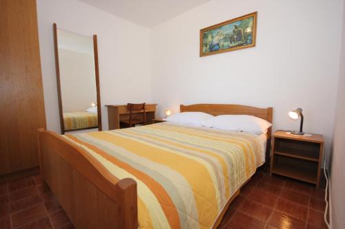a bedroom with a large bed and a mirror at Holiday house with WiFi Ustrine, Cres - 8037 in Ustrine