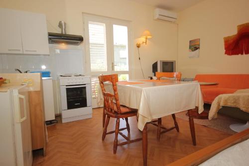 a kitchen and living room with a table and chairs at Apartments and rooms with parking space Srebreno, Dubrovnik - 8959 in Mlini