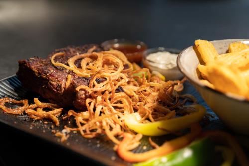 a plate of food with a piece of meat and fries at Köpfle Alpe in Balderschwang