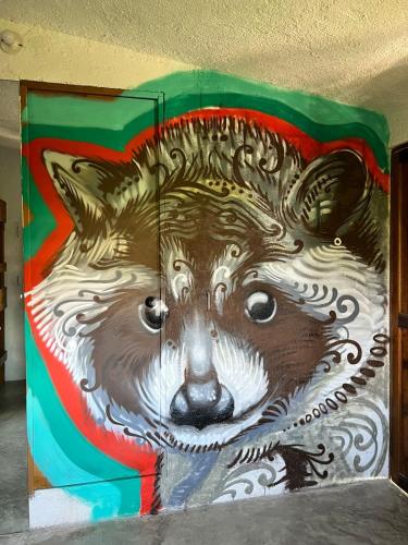 a wall with a painting of a bear on it at Apartment close to the town UTOPIA in Holbox Island
