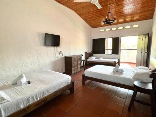 A bed or beds in a room at Hotel Boutique Mirador Las Palmas