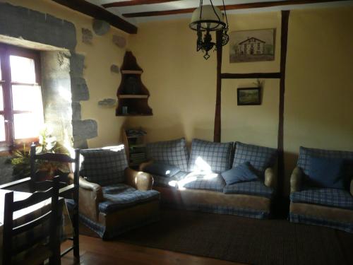 a living room with a couch and two chairs at Etxeberri Landa Etxea in Régil