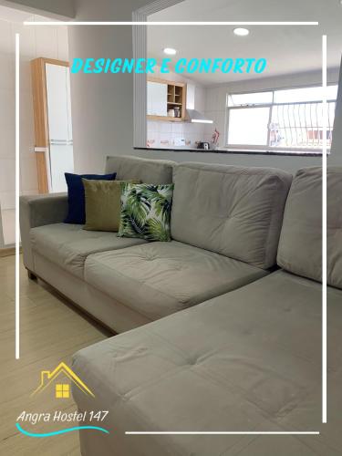 a gray couch in a living room with at Angra Hostel 147 in Angra dos Reis