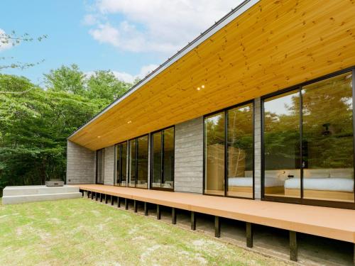 a house with a large group of windows at Rakuten STAY VILLA Aso Kurokawa -101 1LDK Capacity of 6 persons in Minamioguni