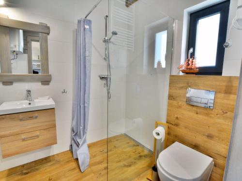 a bathroom with a shower and a toilet and a sink at Comfortable holiday houses with air conditioning close to the sea, Sianozety in Sianozety
