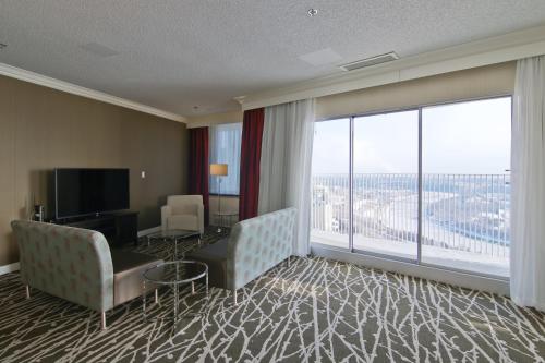 a hotel room with a desk and a large window at Chateau Lacombe Hotel in Edmonton