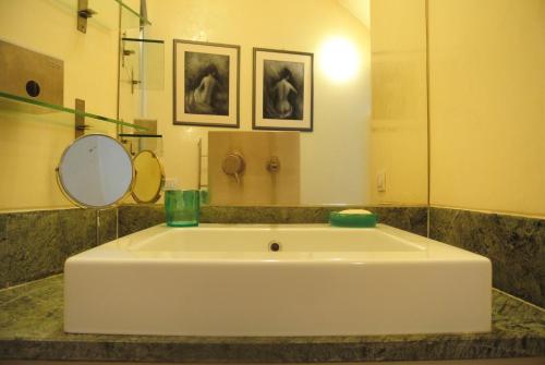 a white tub in a bathroom with a mirror at Ariberto21 in Milan