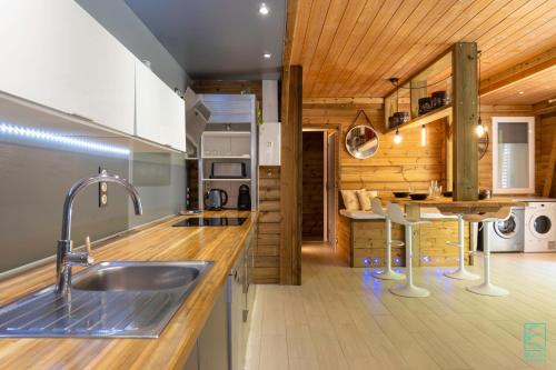 una cucina con lavandino e soffitto in legno di Magnifique et spacieux T2 proche de la plage - La Kiss House a Deshaies