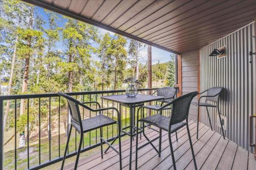 a patio with a table and chairs on a deck at Atrium Unit #108 Condo in Breckenridge