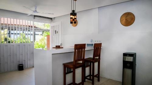 a kitchen with a counter and a chair in it at BALI AMED FEEL HOME VILLA in Amed