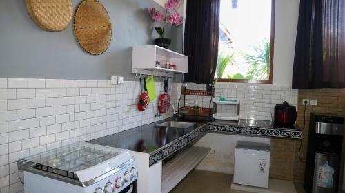 a kitchen with a sink and a counter top at BALI AMED FEEL HOME VILLA in Amed