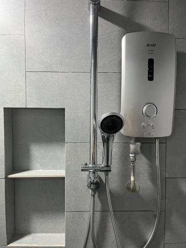 a soap dispenser on the wall of a shower at Splendours Condos@Jesselton Quay in Kota Kinabalu