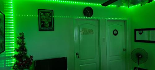 a green room with a christmas tree and lights at Two-Bedroom at San Remo Oasis in Cebu City