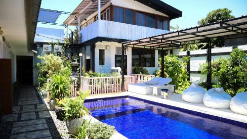 a house with a swimming pool in front of a house at BALI AMED FEEL HOME VILLA in Amed
