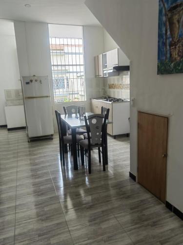 a dining room with a table and chairs in a kitchen at Villa Aurora in Ricaurte