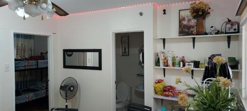 a bathroom with a toilet and some shelves at Two-Bedroom at San Remo Oasis in Cebu City