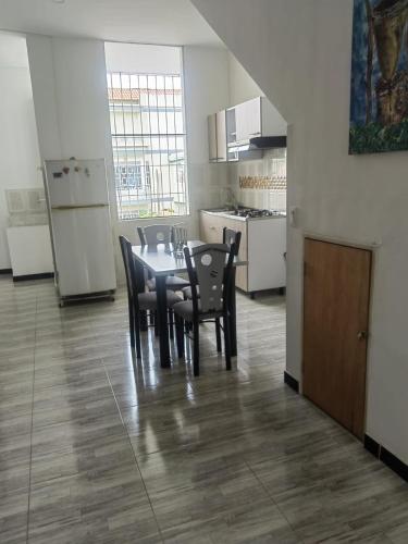 a dining room with a table and chairs in a kitchen at Villa Aurora in Ricaurte