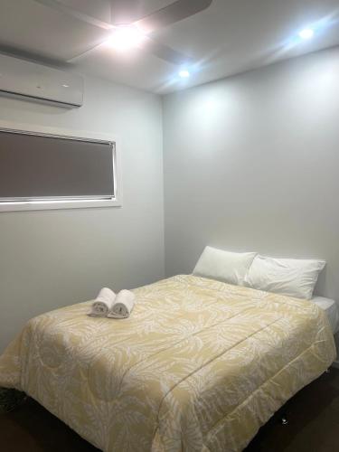 a bedroom with a bed with two slippers on it at Bundalong Villas in Bundalong