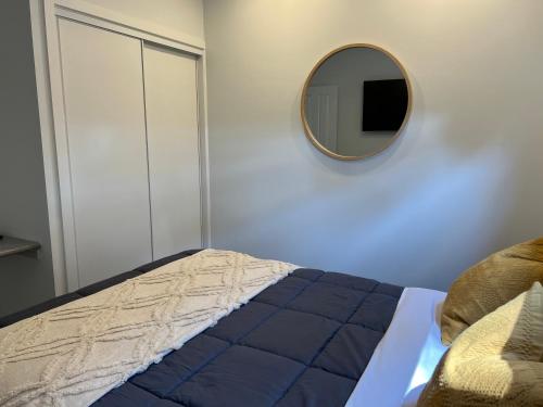 a bedroom with a bed and a mirror on the wall at Bundalong Villas in Bundalong