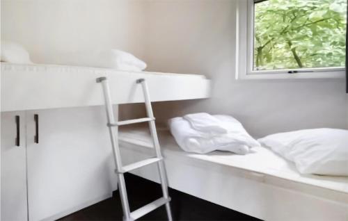a ladder in a room with a bed and a window at 2 Bedroom Stunning stacaravan In Vorden in Vorden