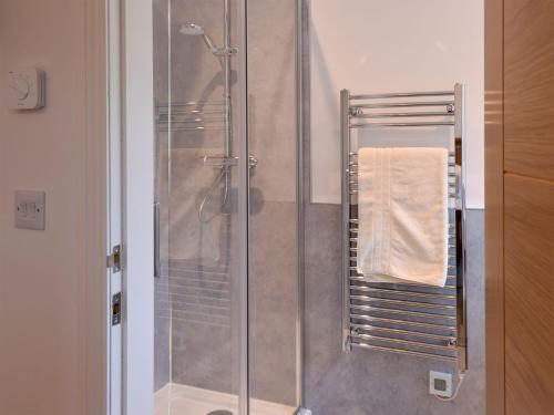 a shower stall in a bathroom with a towel at Inverallan in Amisfield Town