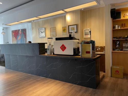 a counter in a coffee shop with a appliance on it at Yoshi Hotel in Tainan