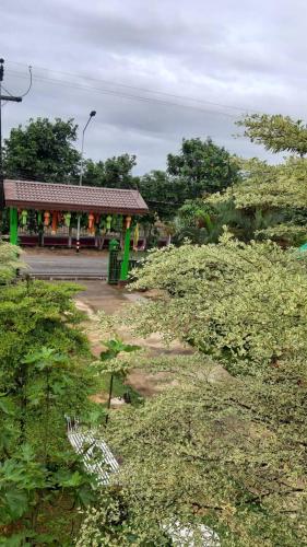 a bus stop with a green in a field at Baan innto resort in Fang