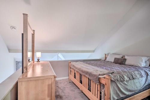 a bedroom with a bed and a dresser in a attic at Ellicottville Townhome about Half Mi to Slopes! in Ellicottville